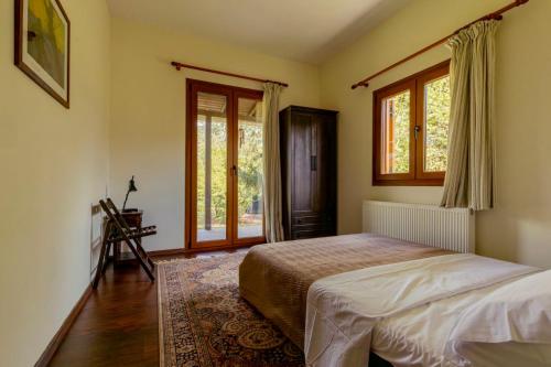 a bedroom with a bed and a window at Friend House in Néa Péramos