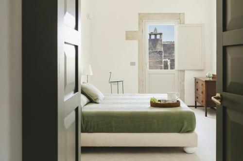 a bedroom with a bed and a dresser and a mirror at La Canonica Suites in Cannole
