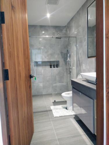a bathroom with a shower and a toilet and a sink at Rawai Villa in Rawai Beach