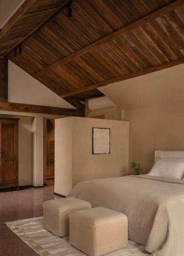 a bedroom with a large bed with two stools at YueLore Retreat in Ta-mien-chen