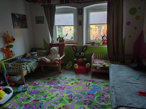 a childs room with a crib and toys in it at Ubytování Okřínek ONE in Okřínek