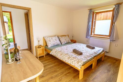 a bedroom with a bed and a table at rekreační areál Vlaštovčí in Rodowitz