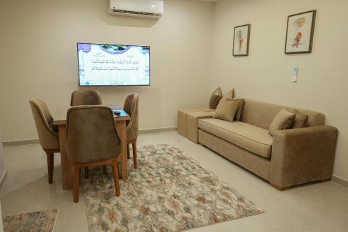 a living room with a couch and a table at Elite hotel in Sheikh Zayed