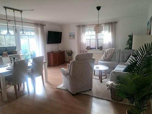 a living room with a couch and chairs and a table at Ferienhaus Sophie in Diekhusen-Fahrstedt