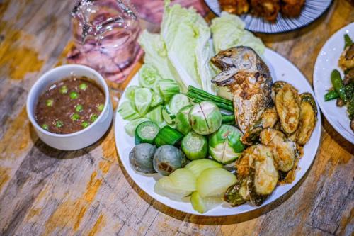 a plate of food with seafood and vegetables on a table at VAA chachoengsao in Ban Hua Sai