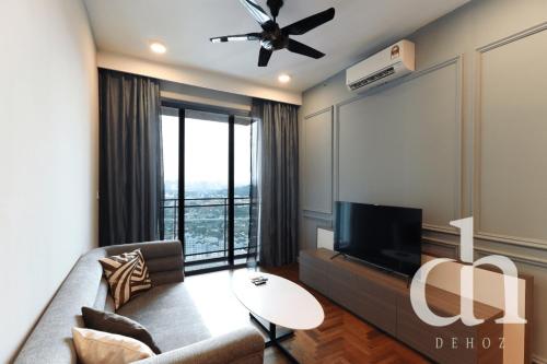 a living room with a couch and a flat screen tv at Bloomsvale Residence Old Klang Road by Dehoz Suites in Kuala Lumpur
