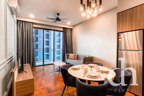 a living room with a table and a dining room at Bloomsvale Residence Old Klang Road by Dehoz Suites in Kuala Lumpur