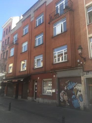 a brick building with a mural on the side of it at Centre de Bruxelles, Studio C in Brussels