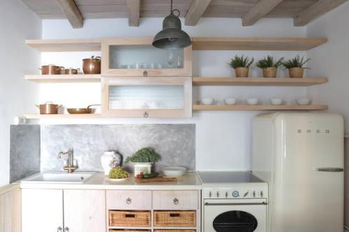 a kitchen with a white refrigerator and a sink at Casa Degrassi - Main square - Seaview in Vrsar
