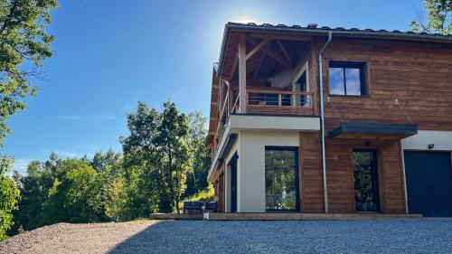 a house on a hill with a garage at Les balcons de saint Apollinaire in Saint-Apollinaire