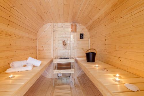 a sauna with a bench in a wooden room at Ferienwohnungen Haus am Strand in Zingst