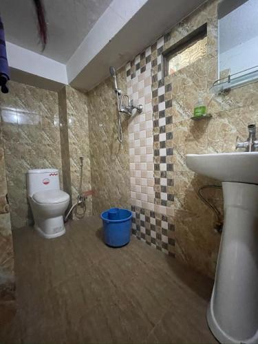 a bathroom with a toilet and a sink at Nirvaan Guest House since 2019 in Kathmandu