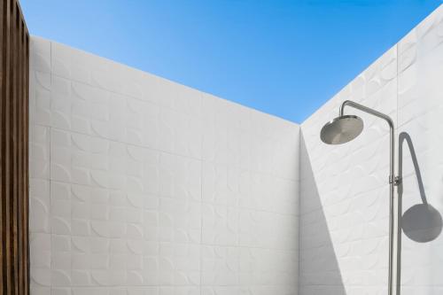 a white brick wall with two lights on it at Villa Angelina in Leeward