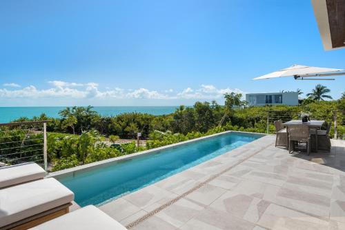a swimming pool with a view of the ocean at Villa Angelina in Leeward