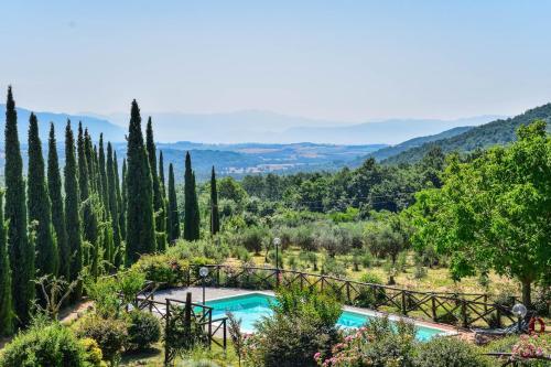 a pool in a garden with trees and a bridge at Casa Vecchia, house with private pool and air conditioning in Toscolano