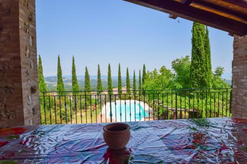 a balcony with a view of a pool and trees at Casa Vecchia, house with private pool and air conditioning in Toscolano
