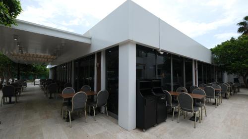 a row of tables and chairs in a building at The Nix Hotel Kemer in Kemer