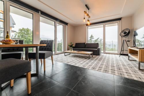 a living room with a table and chairs at Kazalnica Family&Conference Resort in Karpacz