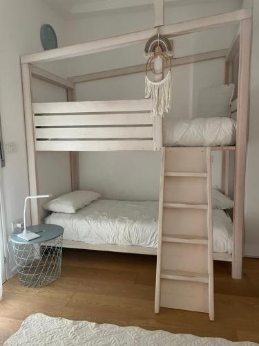 a bunk bed with two bunk beds in a room at Appartamento Vacanze ACQUA E SALE in Marotta