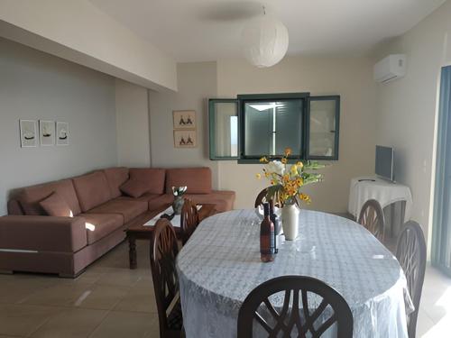a living room with a table and a couch at Villa Sofia with an amazing view in Angón