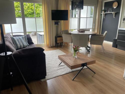 a living room with a couch and a table at Aan de Wiericke in Driebruggen