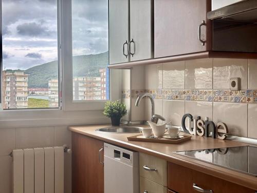 a kitchen with a sink and a window at Vistas al mar, a 1 min de la playa, terraza, wifi in Laredo