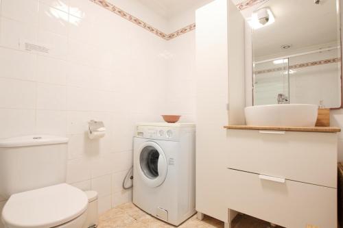ein Badezimmer mit Waschmaschine und Waschbecken in der Unterkunft Ground floor near the beach in Málaga