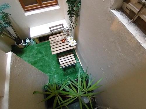 an overhead view of a courtyard with benches and plants at Florence Colonna Spa in Florence