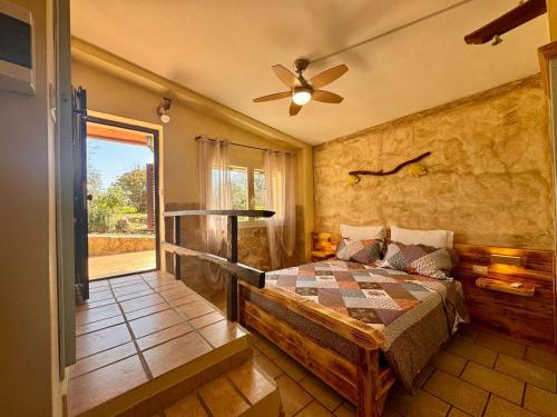 a bedroom with a bed and a ceiling fan at Volpe in Pitigliano