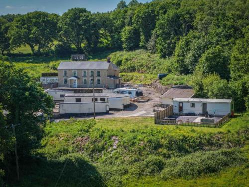 an aerial view of a building in a field at Hopkins Retreat - 3 Bedroom Caravan - Hot Tub in Swansea