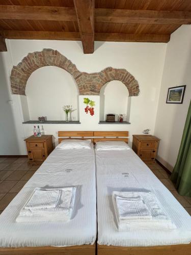 a bedroom with a large bed with two archways at Agriturismo Brusignone in Besana in Brianza