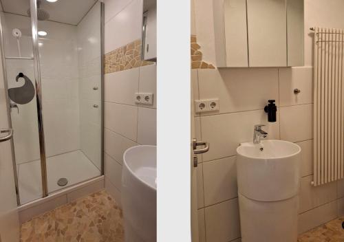 a white bathroom with a sink and a shower at 30 qm Fewo ländliche Lage Nossen in Nossen