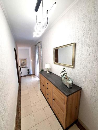 a room with a dresser and a mirror on a wall at Rooms Irena Gregov in Mošćenička Draga