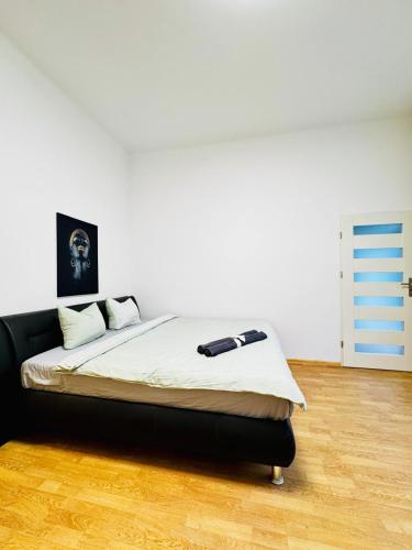 a bedroom with a bed with a black headboard at Lovely 2BR for 5P Peaceful & Central Stay in Klosterneuburg