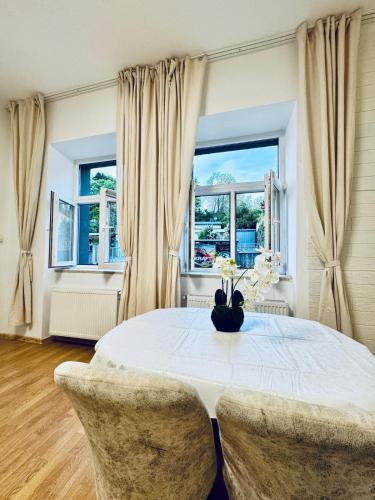 a dining room with a table and two chairs at Lovely 2BR for 5P Peaceful & Central Stay in Klosterneuburg