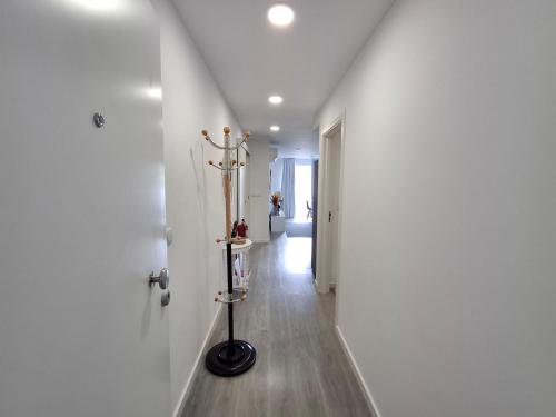 a hallway with a white wall and a white hallway with at Smile and Wave Apartment in Ponta Delgada