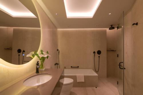 a bathroom with a sink and a toilet and a shower at Hotel Yak & Yeti in Kathmandu