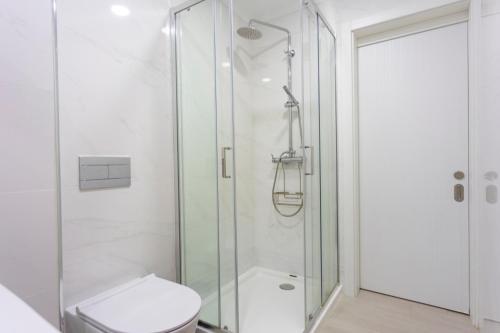 a bathroom with a shower and a toilet at Moradia Valdemar in Nazaré
