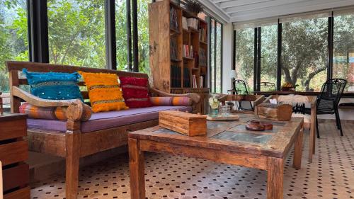 a living room with a couch and a table at Dar Tidyan - Maison d'hôtes in Igzi Ou Fella