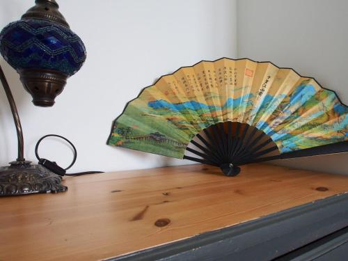 a fan sitting on a table next to a lamp at Musselburgh - Spacious Family-Friendly Home with Garden and Office in Musselburgh