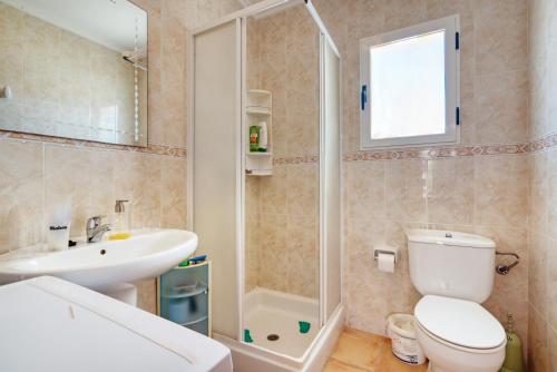 a bathroom with a toilet and a sink and a shower at Oliva Avinyo in Oliva