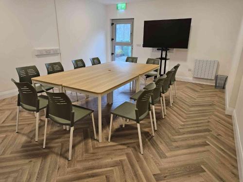 a conference room with a large wooden table and chairs at Main Street Swinford! in Swinford