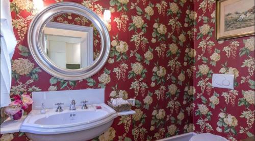 a bathroom with a sink and a mirror at Villa La Memma - Private Villa with Pool for 6 in Case Malva