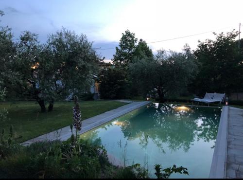 a swimming pool in a yard with trees at Villa La Memma - Private Villa with Pool for 6 in Case Malva