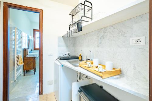 Una cocina con fregadero y escalera. en Casa Bianca, en Castelnuovo