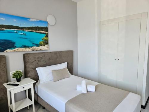 a small bedroom with a bed and a table at LEVEL Mallorca - Living in Playa de Palma