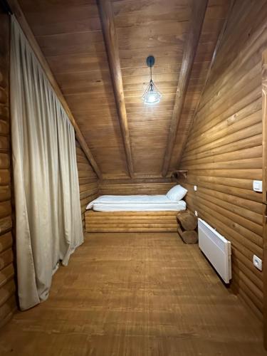 a small room with a bed in a wooden cabin at Luxury Glamping Grabovica - Vital Resort in Skender Vakuf