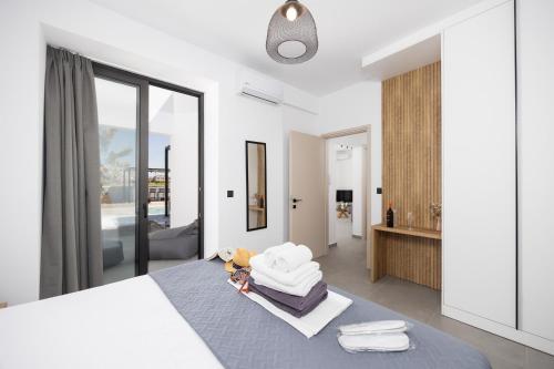 a bedroom with a bed and a living room at Villa 13 Zendo in Kolymbia