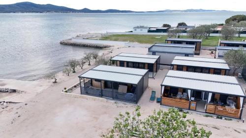 an aerial view of buildings on a beach next to the water at Rock Mobile Home in Sveti Petar
