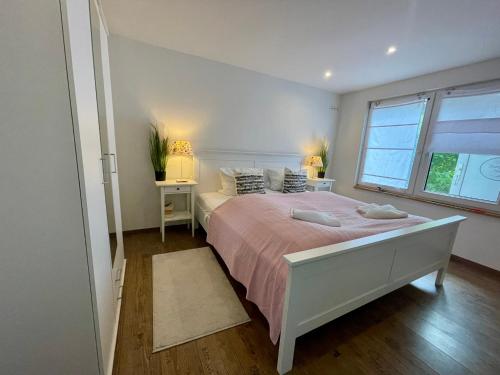 a bedroom with a large bed and a window at Holiday Rügen Putbus in Putbus
